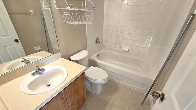 an empty room with a window and a chandelier fan