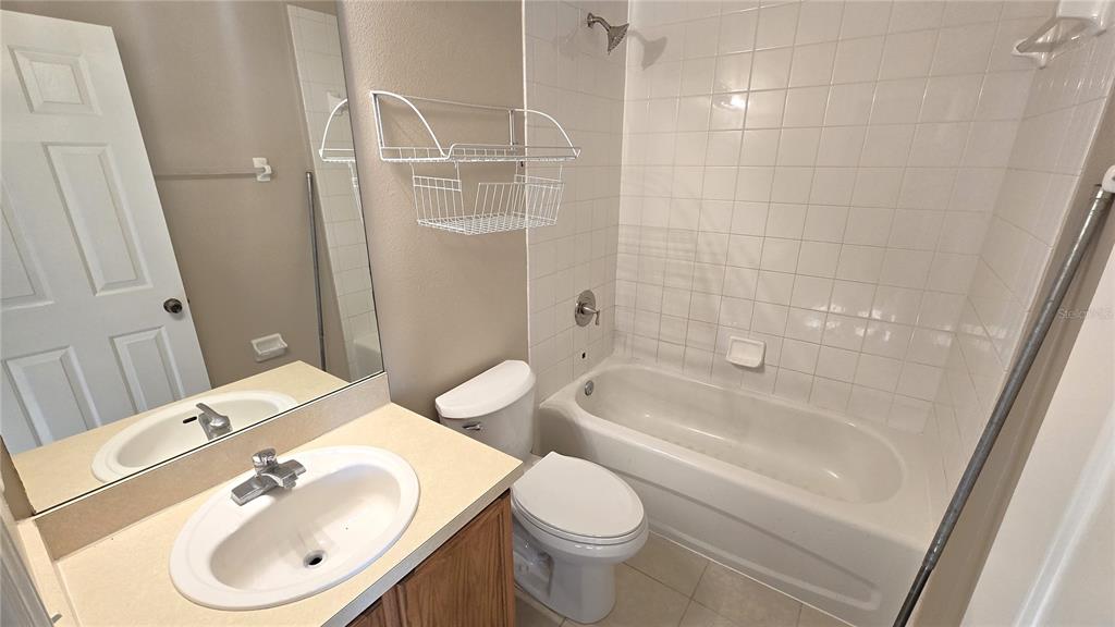 1302 Denman Court Wesley Chapel, FL 33543 - Photo 22 of 28 a bathroom with a sink a toilet and shower