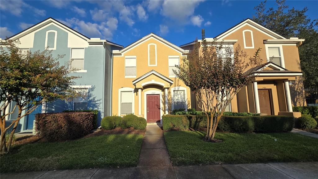 1302 Denman Court Wesley Chapel, FL 33543 - Photo 5 of 28 a front view of a house with a yard and garage