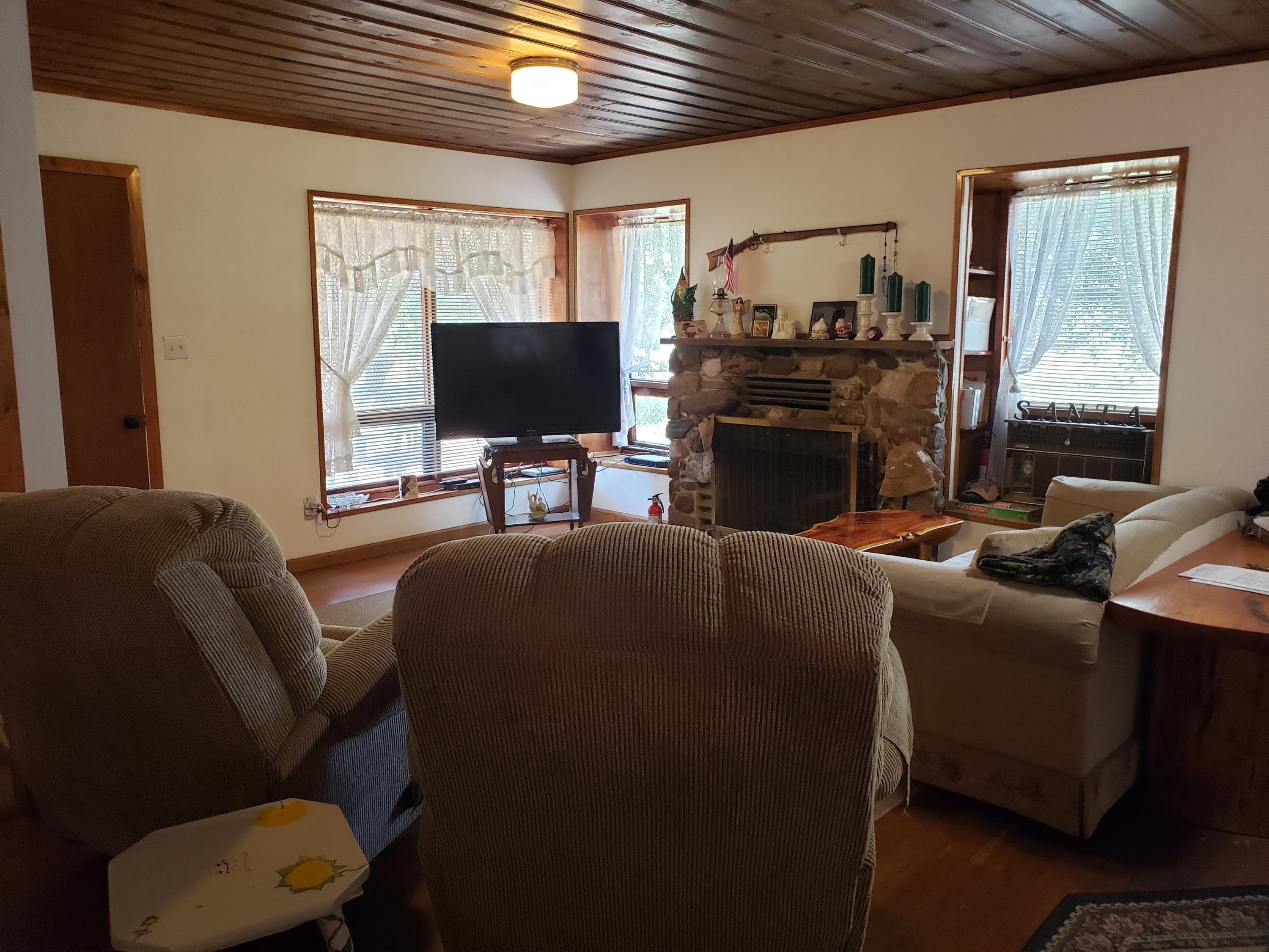 203 South Kodz Road Payson, AZ 85541 - Photo 6 of 15 a living room with furniture a flat screen tv and a fireplace