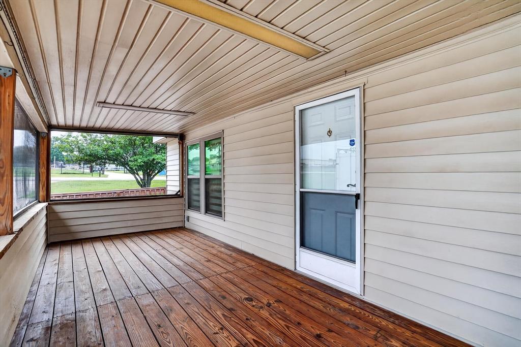 7757 Berry Road Burleson, TX 76028 - Photo 24 of 36 Screened porch featuring wood-finish flooring, light-toned siding, and multiple window openings