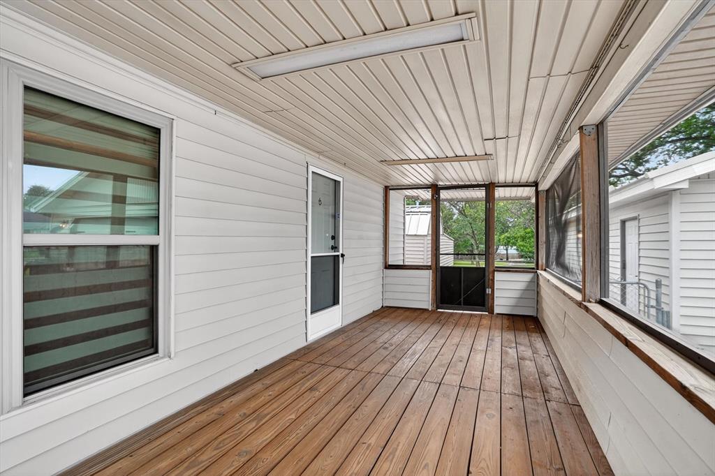 7757 Berry Road Burleson, TX 76028 - Photo 25 of 36 Screened porch featuring wood-finish flooring, white siding, and a beadboard ceiling with flush-mount lighting