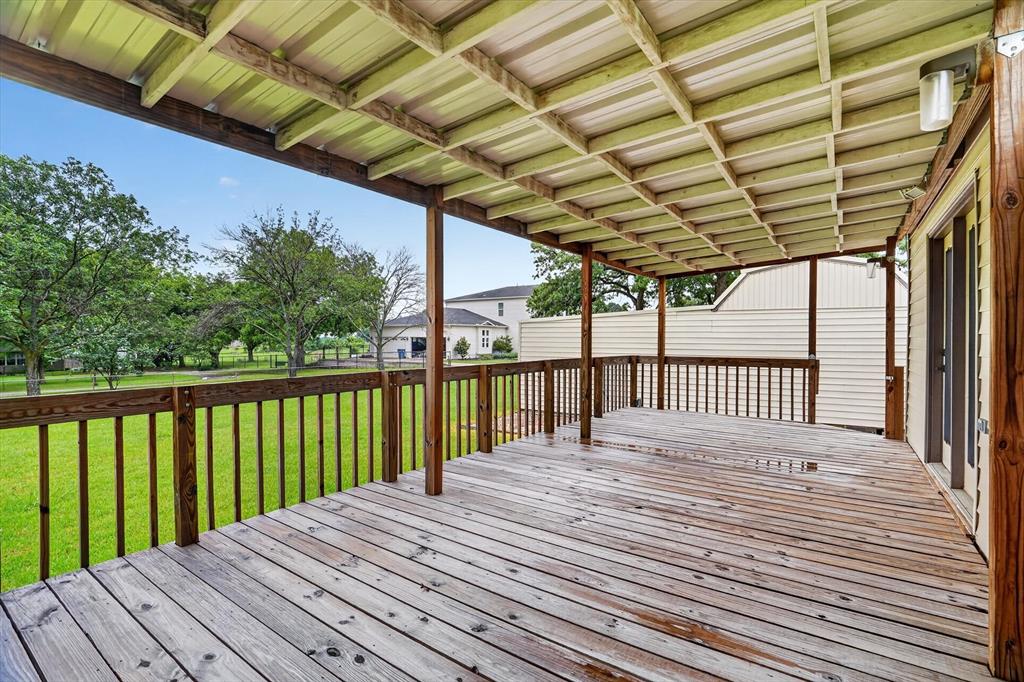 7757 Berry Road Burleson, TX 76028 - Photo 30 of 36 Expansive wood deck with a full metal roof covering