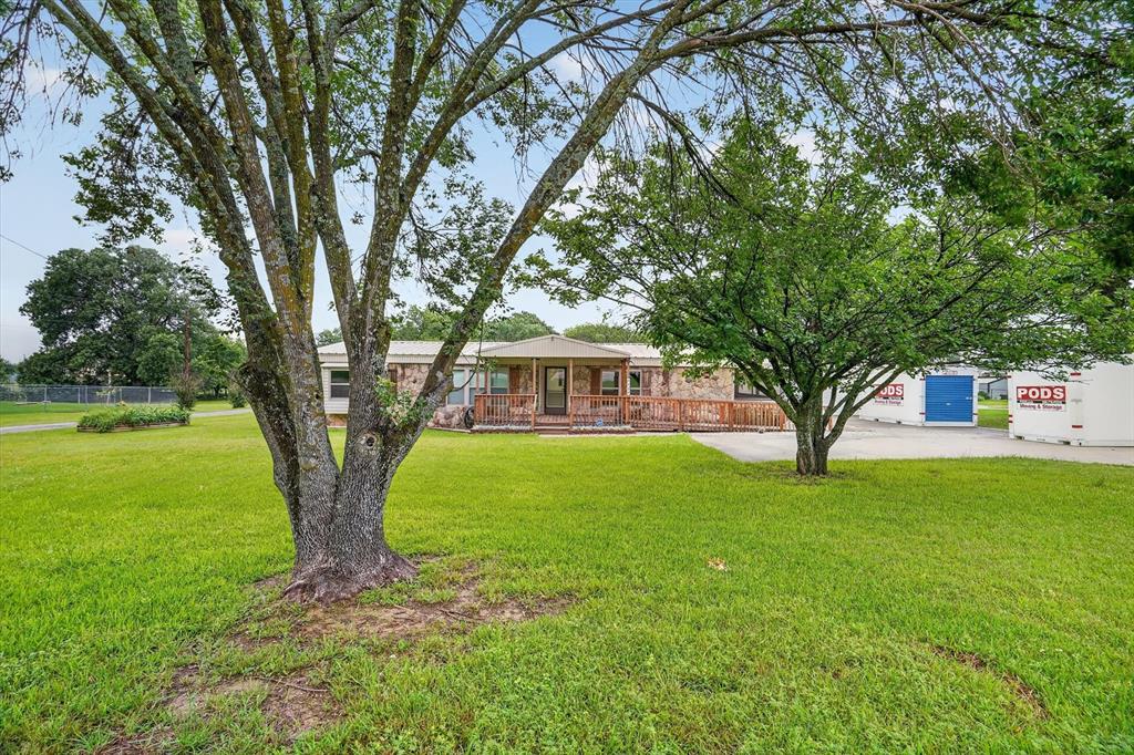 7757 Berry Road Burleson, TX 76028 - Photo 3 of 36 Expansive green lawn with mature trees
