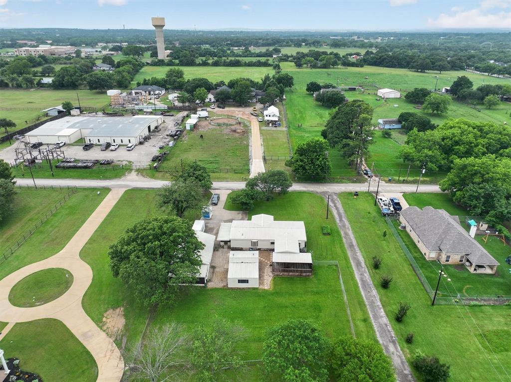 7757 Berry Road Burleson, TX 76028 - Photo 34 of 36 Expansive property featuring a circular driveway, mature trees, open green spaces, and multiple structures