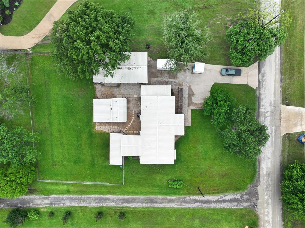 7757 Berry Road Burleson, TX 76028 - Photo 35 of 36 Expansive property featuring a main structure with multiple auxiliary buildings, extensive green lawn areas, and mature trees