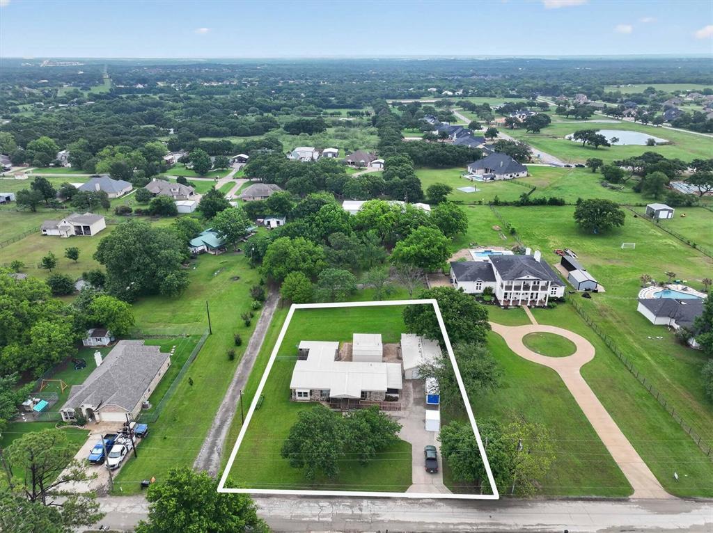7757 Berry Road Burleson, TX 76028 - Photo 4 of 36 Aerial view showcasing the property's expansive green lawn and surrounding mature trees