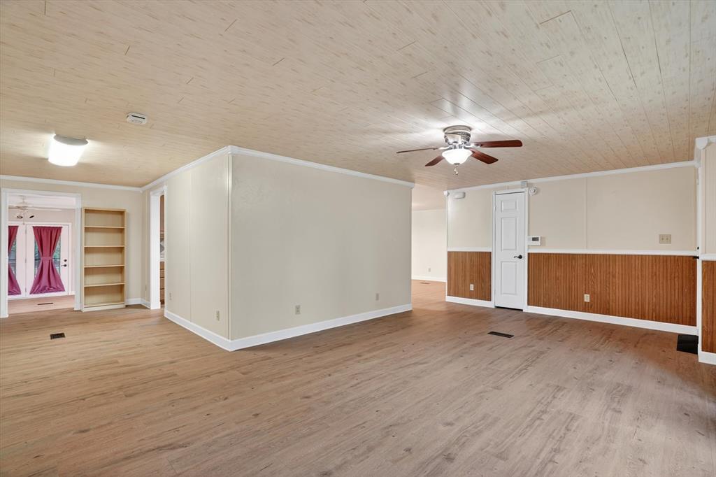 7757 Berry Road Burleson, TX 76028 - Photo 10 of 36 Spacious interior featuring wood-finish flooring, white baseboards, and a paneled ceiling