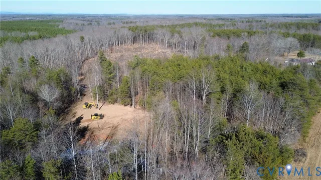 a view of a lake with a yard and large trees