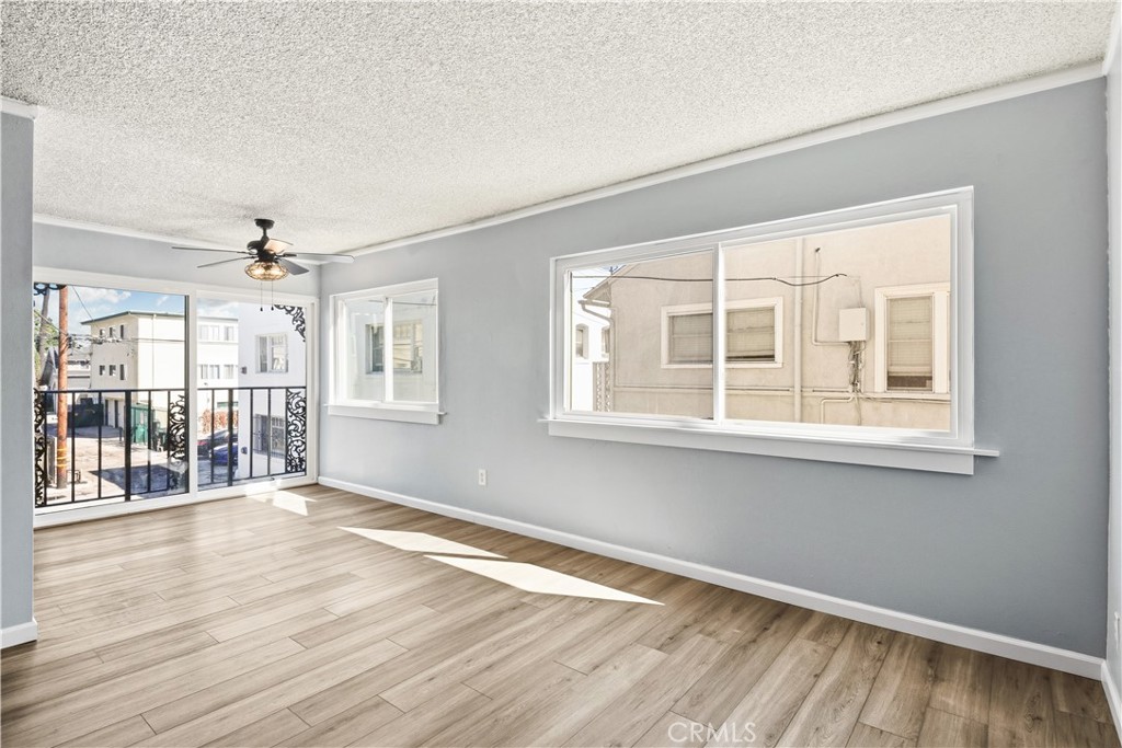 615 East Broadway, Unit 204 Long Beach, CA 90802 - Photo 1 of 27 a view of an empty room with wooden floor and a window