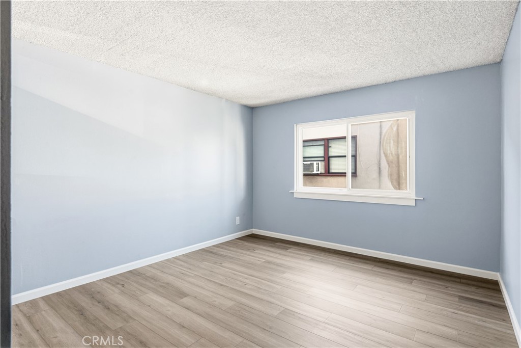 615 East Broadway, Unit 204 Long Beach, CA 90802 - Photo 12 of 27 a view of a big room with wooden floor and windows