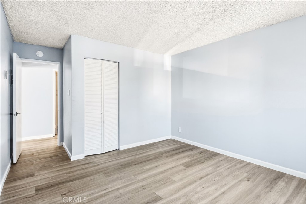 615 East Broadway, Unit 204 Long Beach, CA 90802 - Photo 13 of 27 a view of an empty room with wooden floor and closet