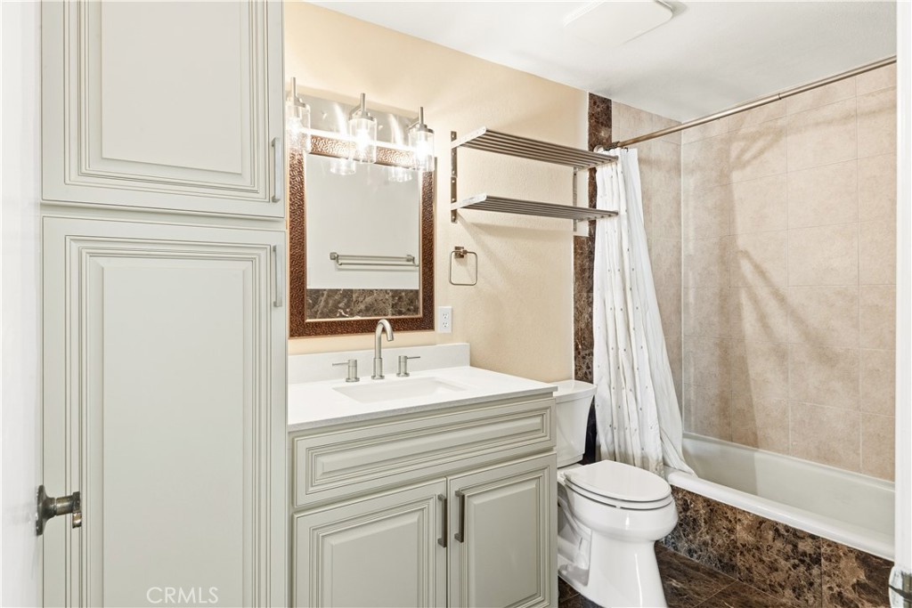 615 East Broadway, Unit 204 Long Beach, CA 90802 - Photo 15 of 27 a bathroom with a sink a toilet a mirror and shower