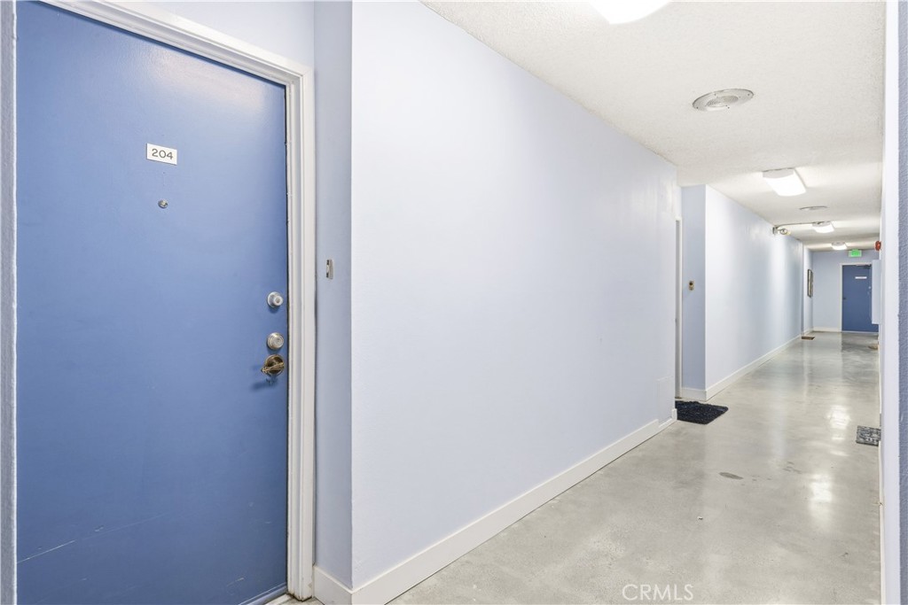 615 East Broadway, Unit 204 Long Beach, CA 90802 - Photo 16 of 27 a view of a hallway with wooden floor