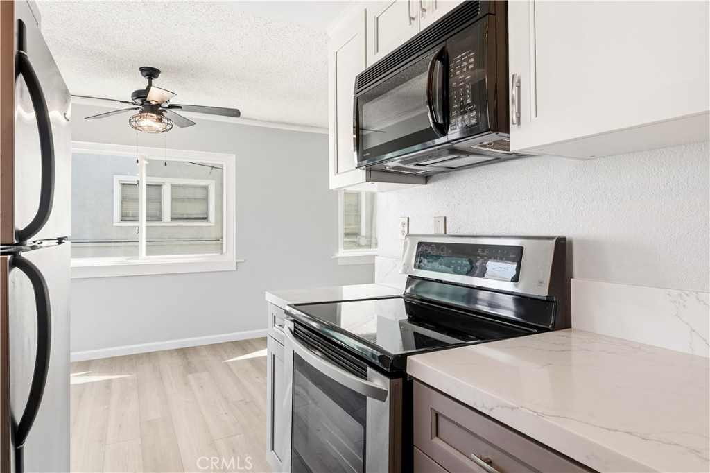 615 East Broadway, Unit 204 Long Beach, CA 90802 - Photo 6 of 27 a kitchen with a stove microwave and a sink