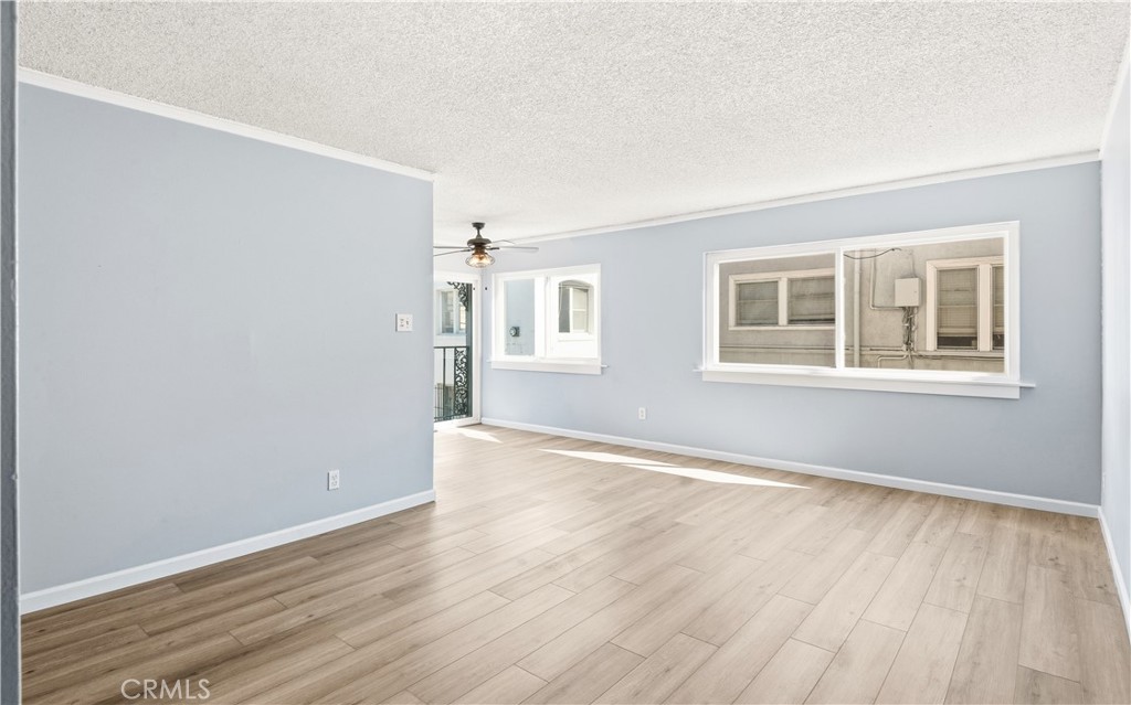615 East Broadway, Unit 204 Long Beach, CA 90802 - Photo 10 of 27 a view of an empty room with wooden floor and a window