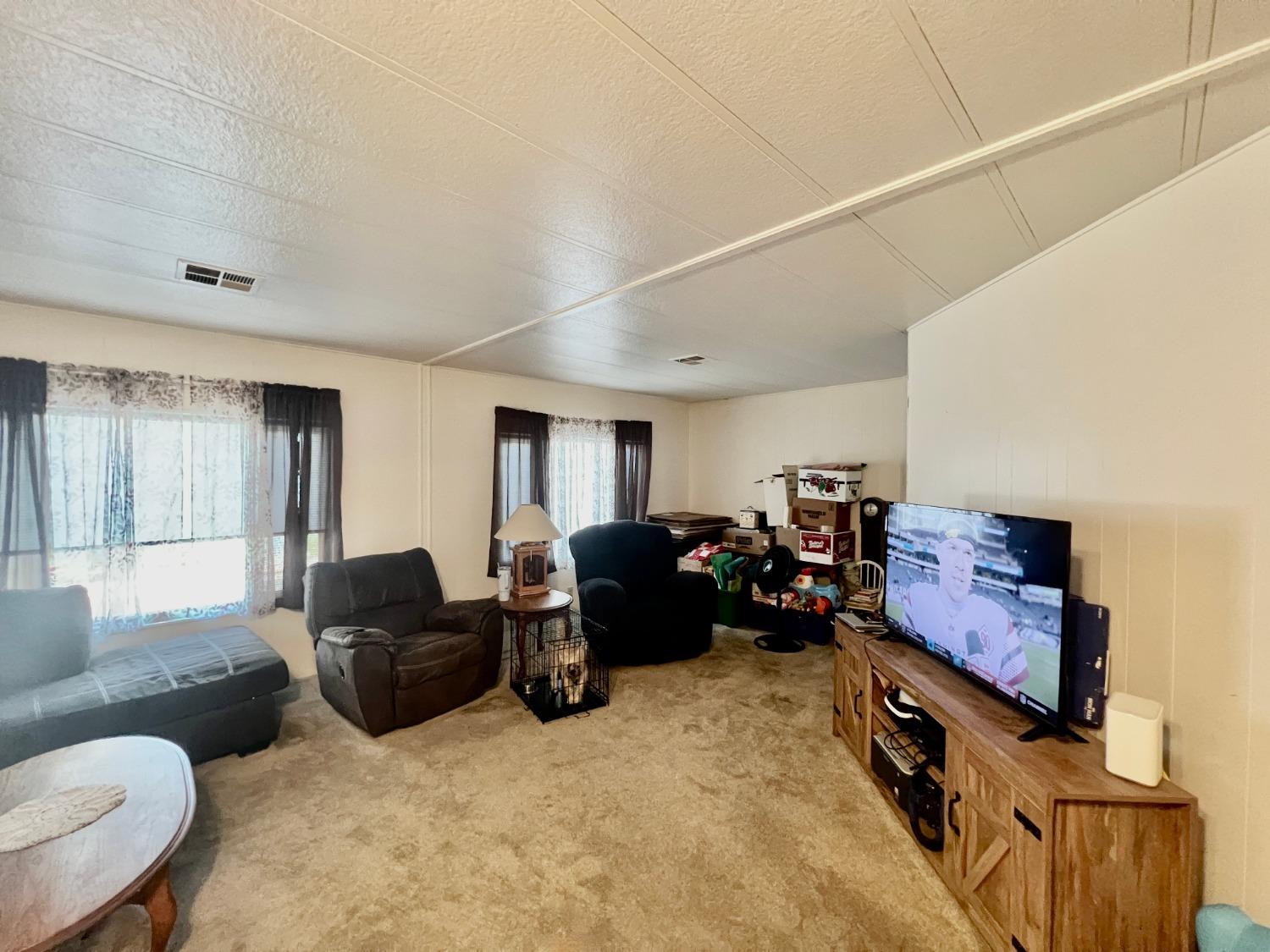 6008 Cackler Lane, Unit 88 Citrus Heights, CA 95621 - Photo 11 of 21 a living room with furniture and a flat screen tv