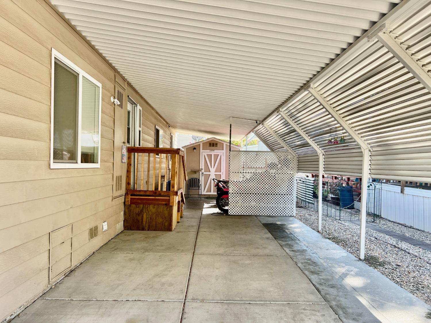 6008 Cackler Lane, Unit 88 Citrus Heights, CA 95621 - Photo 6 of 21 a view of a patio with table and chairs with wooden roof and stairs