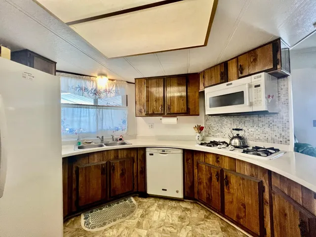 a kitchen with a sink stove and microwave