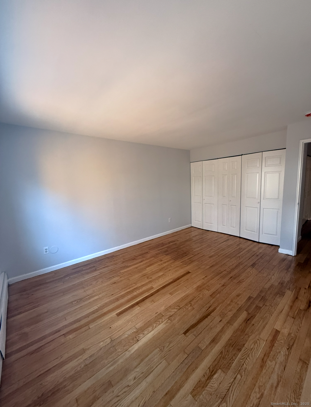 10 Highland Street, Unit H West Haven, CT 06516 - Photo 3 of 5 a view of empty room with wooden floor