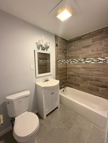 a bathroom with a toilet a sink and bathtub