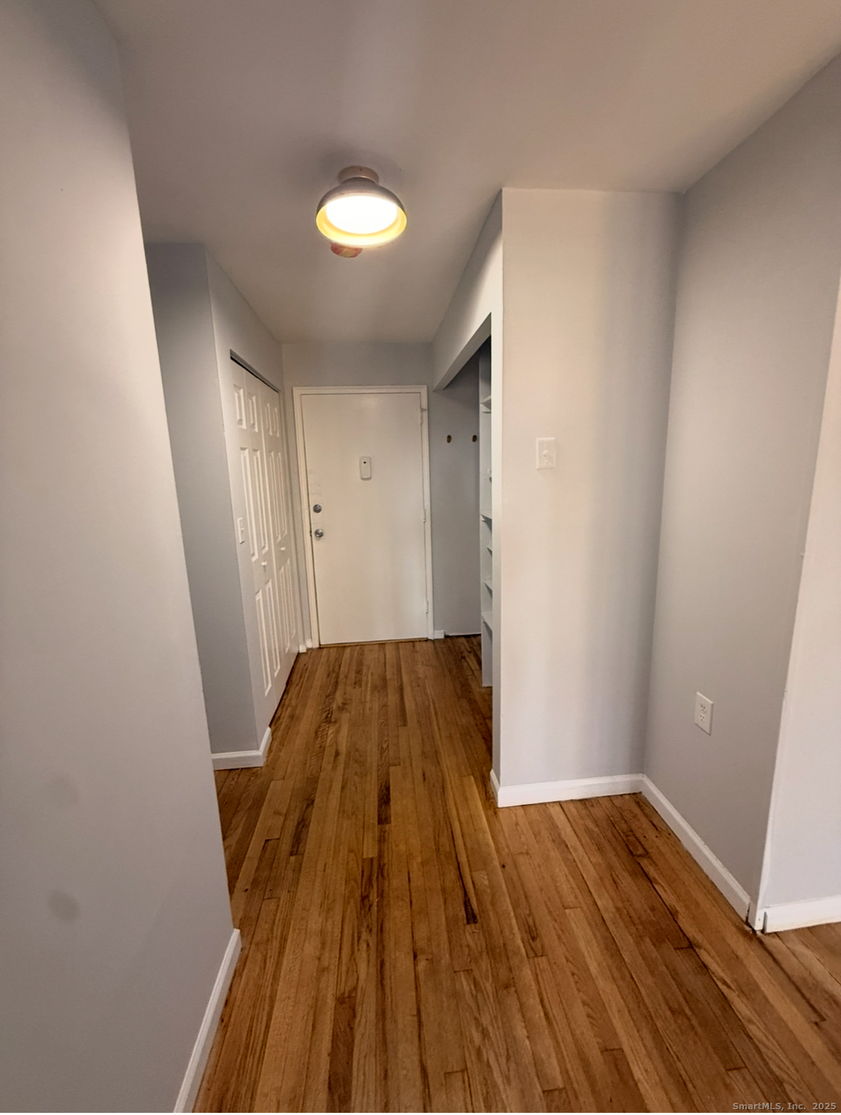 10 Highland Street, Unit H West Haven, CT 06516 - Photo 5 of 5 a view of wooden floor in a room