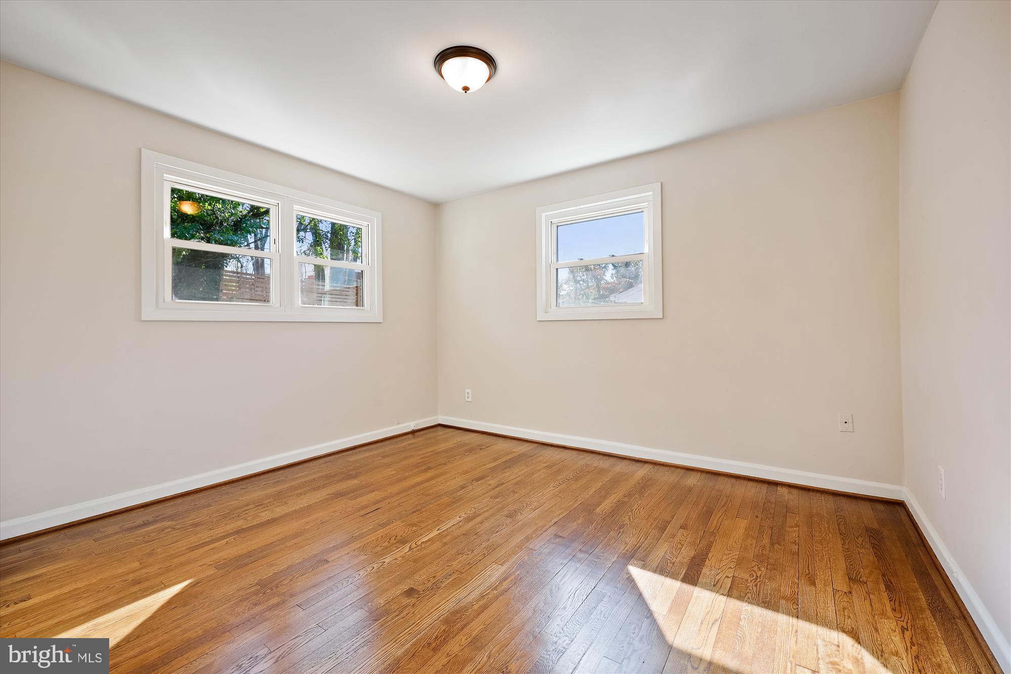908 Whitehall Street Silver Spring, MD 20901 - Photo 28 of 76 a view of an empty room with wooden floor and a window