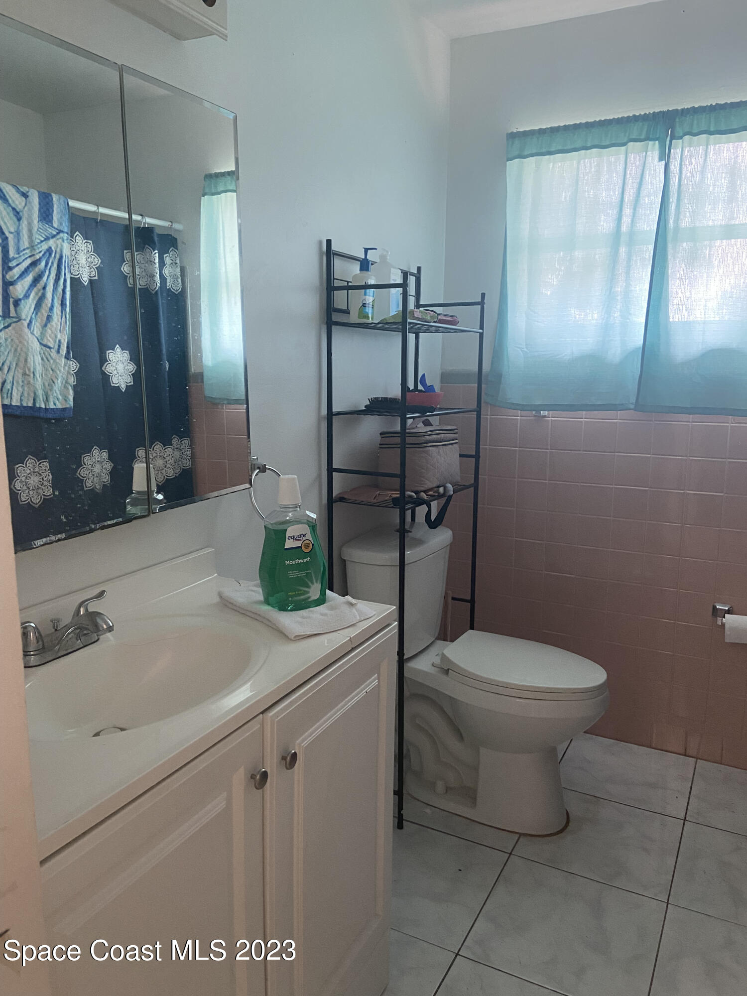 2321 Sarno Road Melbourne, FL 32935 - Photo 6 of 9 a bathroom with a granite countertop toilet sink and mirror