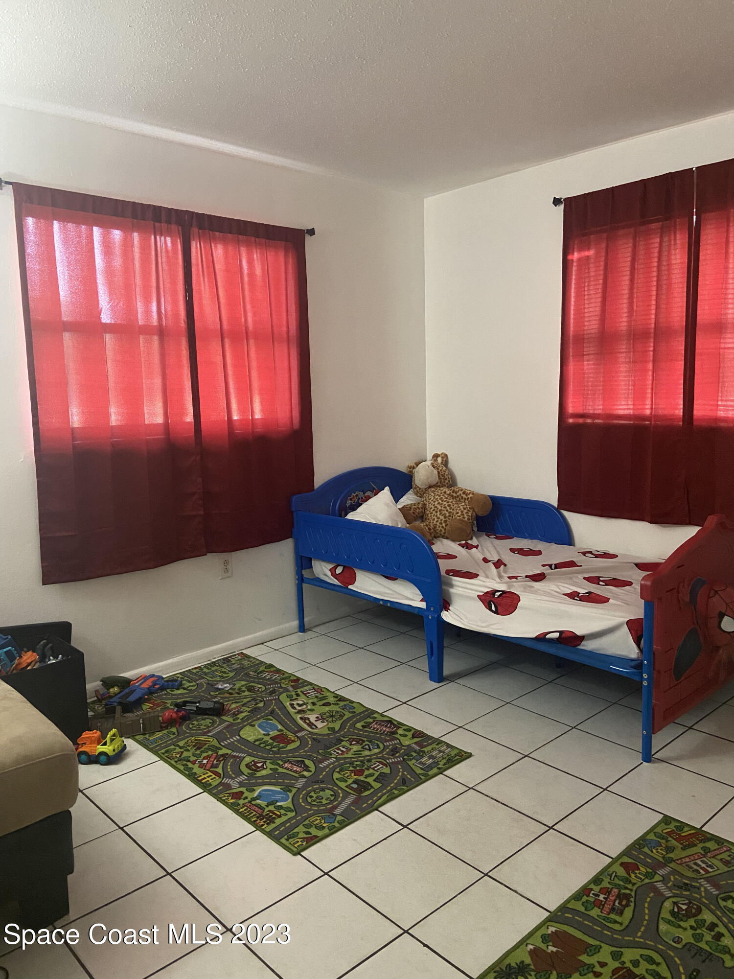 2321 Sarno Road Melbourne, FL 32935 - Photo 7 of 9 a bedroom with a bed and window
