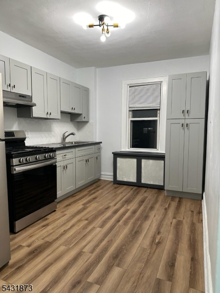 32 Hamilton Avenue, Unit 2 Fairview, NJ 07022 - Photo 10 of 30 a kitchen with a stove and a sink