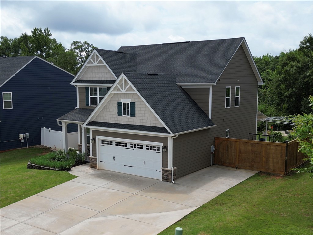 224 Bronson Ridge Anderson, SC 29621 - Photo 23 of 42 A welcoming front exterior showcasing tasteful siding, a concrete driveway, and attached garage.