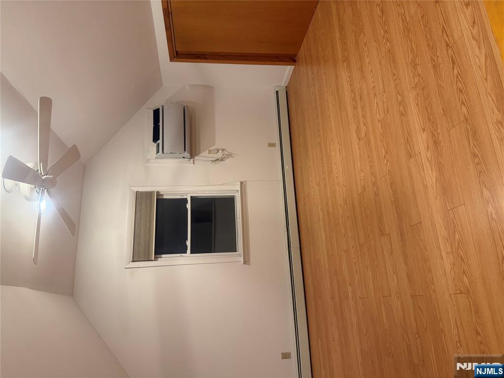 899 Maple Avenue, Unit 2 Ridgefield, NJ 07657 - Photo 2 of 8 a view of an empty room with wooden floor