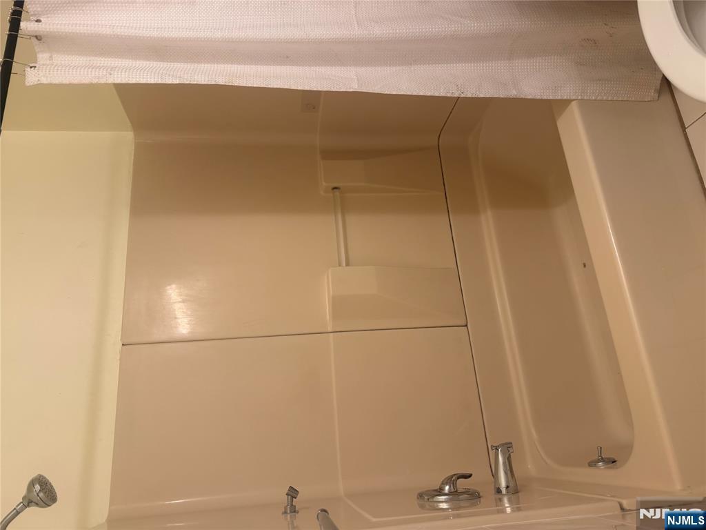 899 Maple Avenue, Unit 2 Ridgefield, NJ 07657 - Photo 4 of 8 a bathroom with a bathtub