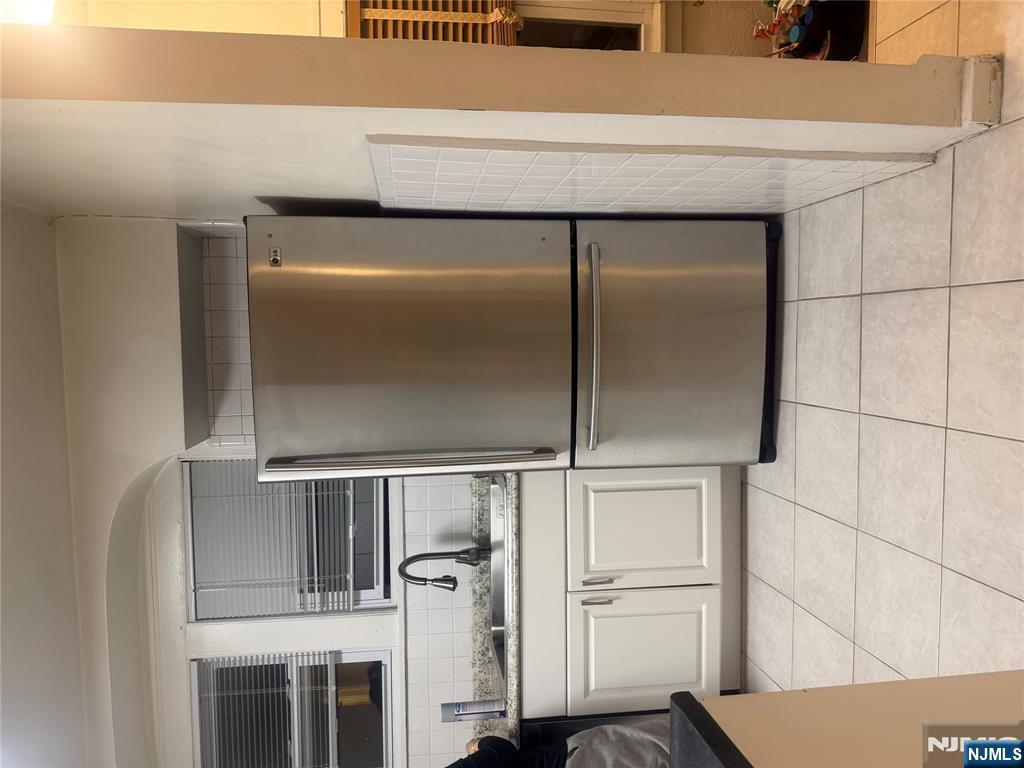 899 Maple Avenue, Unit 2 Ridgefield, NJ 07657 - Photo 6 of 8 a white refrigerator freezer sitting inside of a kitchen