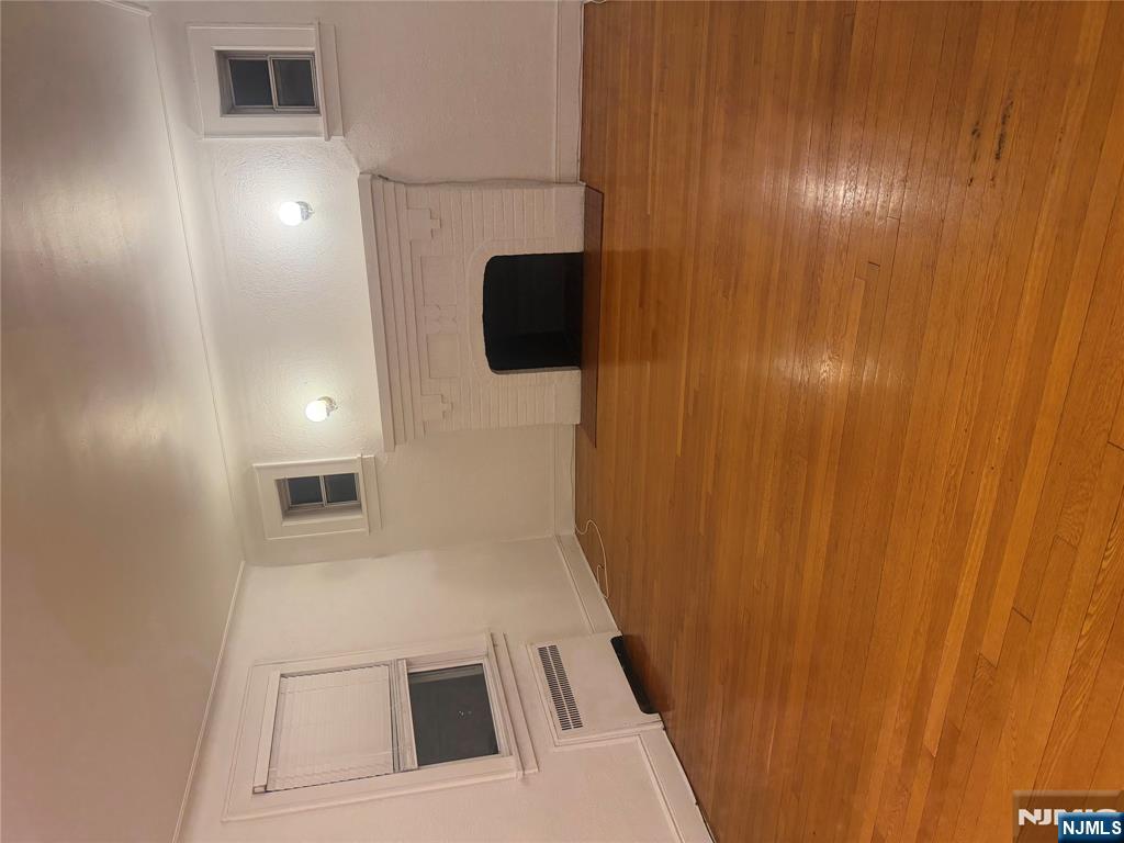 899 Maple Avenue, Unit 2 Ridgefield, NJ 07657 - Photo 7 of 8 a view of a room with an empty space and a fireplace