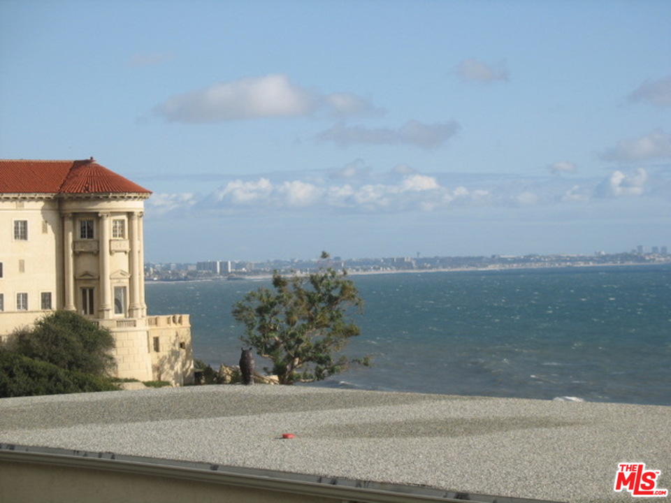 18057 Coastline Drive, Unit 5 Malibu, CA 90265 - Photo 16 of 21 a front view of a house with a yard and lake view