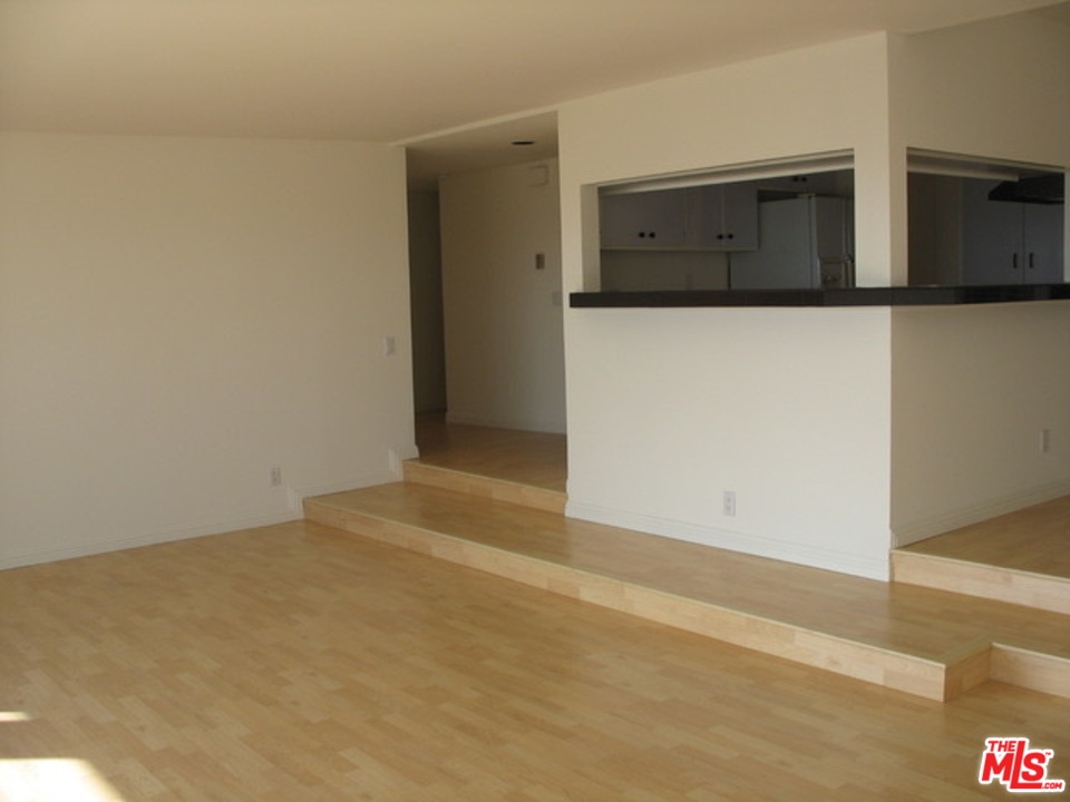 18057 Coastline Drive, Unit 5 Malibu, CA 90265 - Photo 5 of 21 a view of an empty room with wooden floor