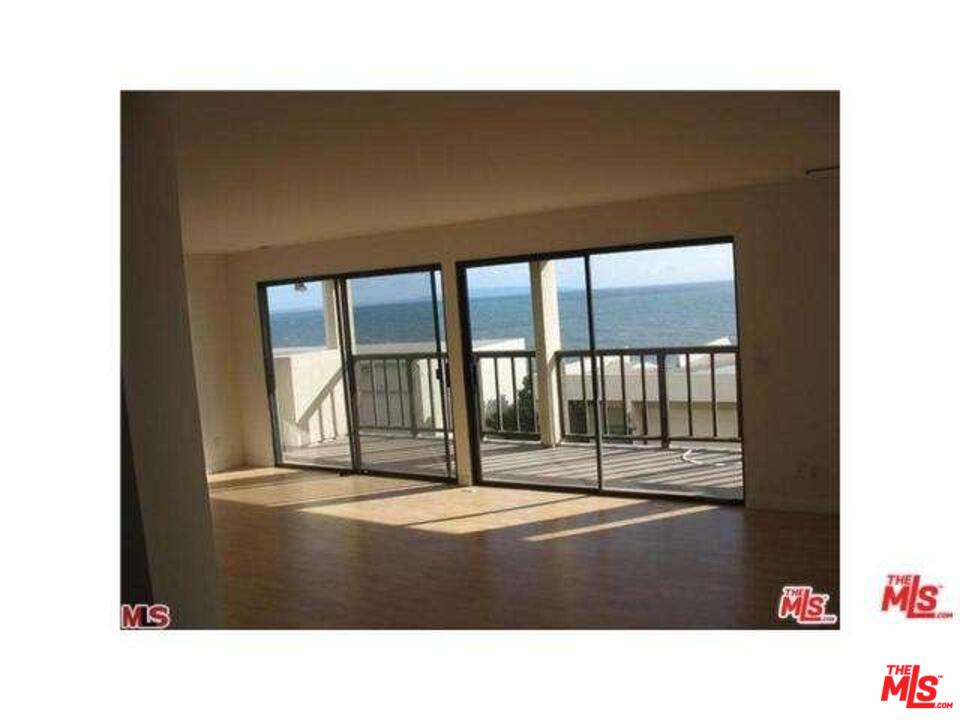 18057 Coastline Drive, Unit 5 Malibu, CA 90265 - Photo 6 of 21 a black and white photo of a living room