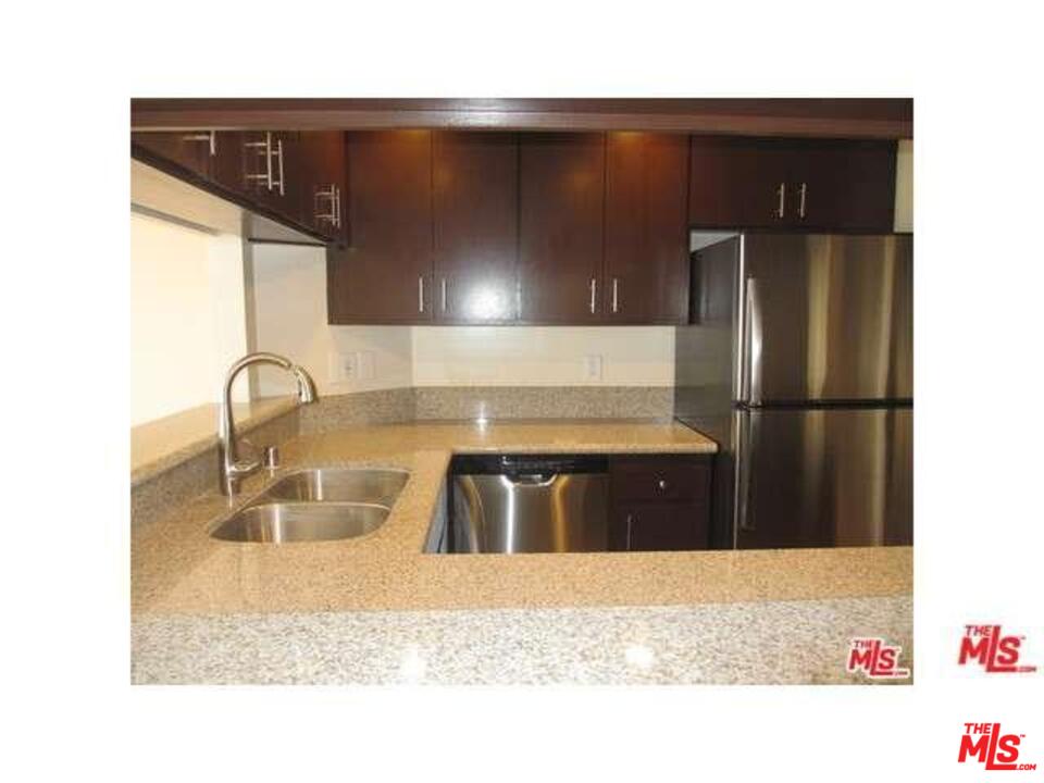 18057 Coastline Drive, Unit 5 Malibu, CA 90265 - Photo 8 of 21 a kitchen with a sink and a refrigerator