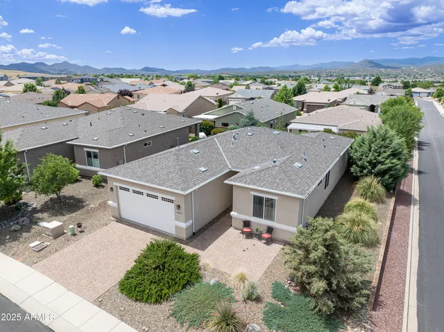an aerial view of a house with a yard and lake view