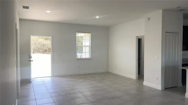 an empty room with windows and closet