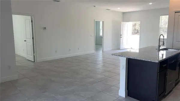 a view of kitchen with granite countertop cabinets and sink