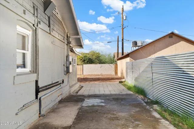 a view of a pathway of a house with a yard