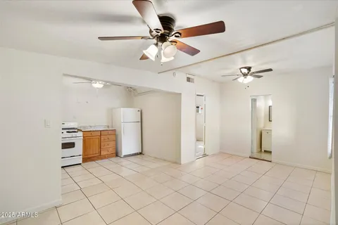 a view of a kitchen with furniture and a ceiling fan