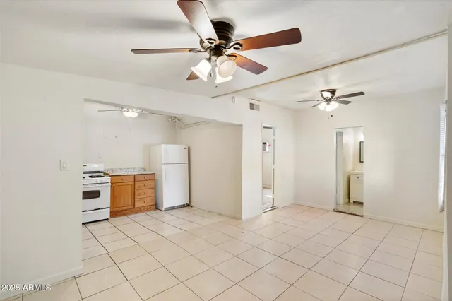 a view of a kitchen with furniture and a ceiling fan