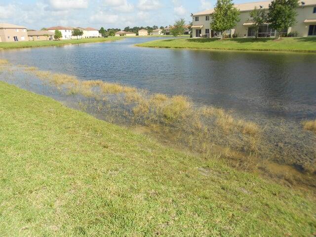 2218 Rockport Road Port St. Lucie, FL 34953 - Photo 19 of 20 a view of a lake with houses