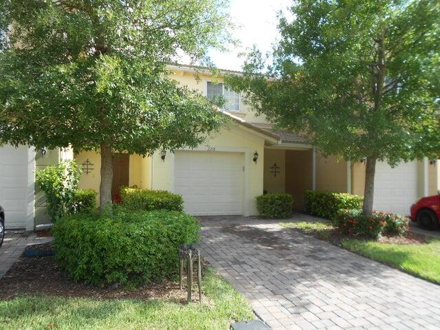 2218 Rockport Road Port St. Lucie, FL 34953 - Photo 2 of 20 a front view of a house with garden