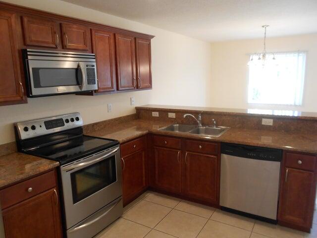 2218 Rockport Road Port St. Lucie, FL 34953 - Photo 10 of 20 a kitchen with a sink stove and microwave