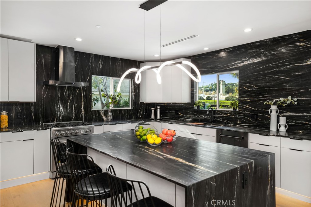 2982 Glendale Boulevard Los Angeles, CA 90039 - Photo 12 of 47 a kitchen with stainless steel appliances granite countertop a stove a sink dishwasher and cabinets with wooden floor