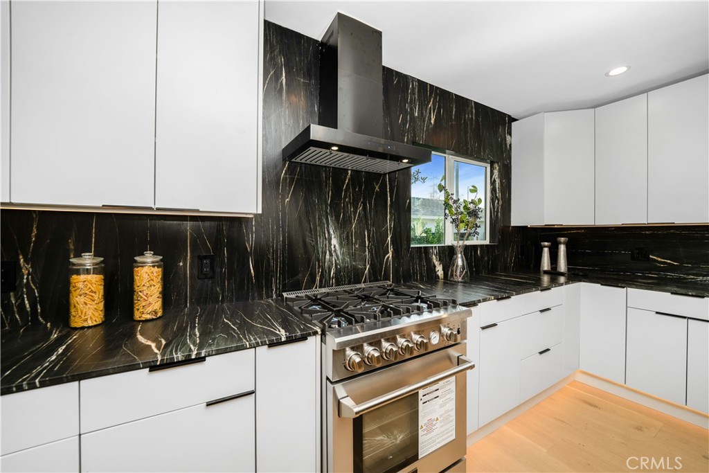 2982 Glendale Boulevard Los Angeles, CA 90039 - Photo 13 of 47 a kitchen with granite countertop a stove a sink and a microwave